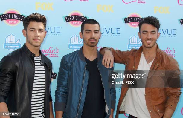 Musicians Nick Jonas, Joe Jonas, and Kevin Jonas of the Jonas Brothers arrive at the Fox Teen Choice Awards 2013 held at the Gibson Amphitheatre on...