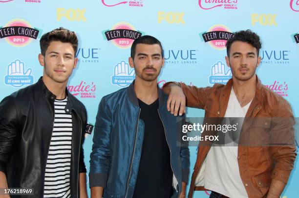 Musicians Nick Jonas, Joe Jonas, and Kevin Jonas of the Jonas Brothers arrive at the Fox Teen Choice Awards 2013 held at the Gibson Amphitheatre on...