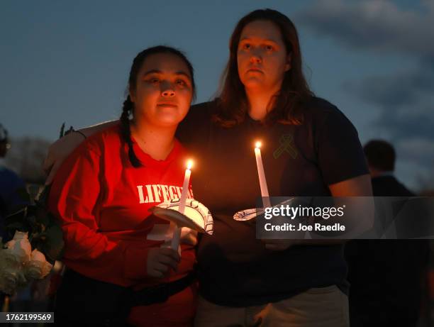 Madison Duong and Gabby Fevens during a candlelight vigil to honor the victims of the Lewiston shootings on October 28, 2023 in Lisbon, Maine. Card...