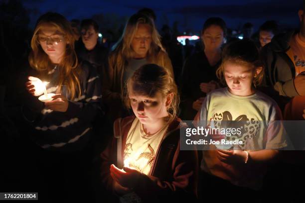 Sadie Huntley during a candlelight vigil to honor the victims of the Lewiston shootings on October 28, 2023 in Lisbon, Maine. Card killed 18 people...