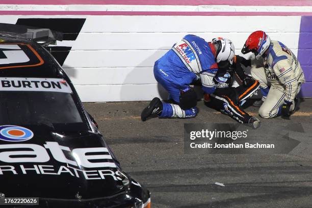 Jeb Burton, driver of the State Water Heaters Chevrolet, is assisted by the American Medical Response safety crew after an on-track incident to end...