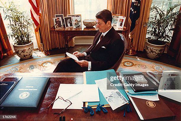 Former U.S. President Ronald Reagan prepares a speech at his desk in the Oval Office for a Joint Session of Congress on April 28, 1981. Reagan turns...
