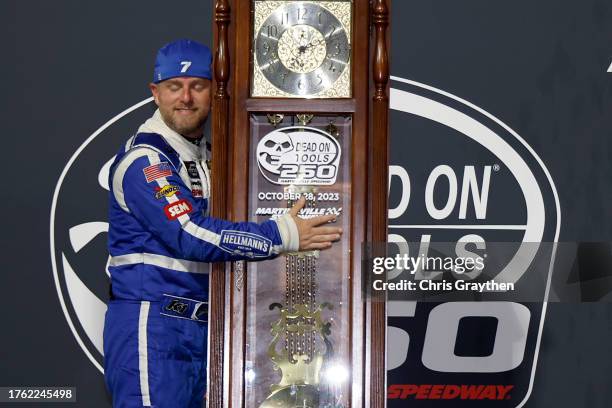 Justin Allgaier, driver of the Hellmann's Chevrolet, embraces the Ridgeway grandfather clock in victory lane after winning the NASCAR Xfinity Series...