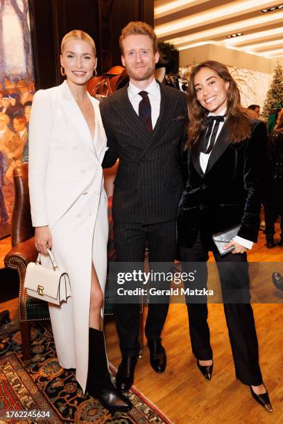 Lena Gercke, André Schürrle and Anna Schürrle, wearing Ralph Lauren, attend an event to launch the Ralph Lauren Holiday takeover at KaDeWe on...