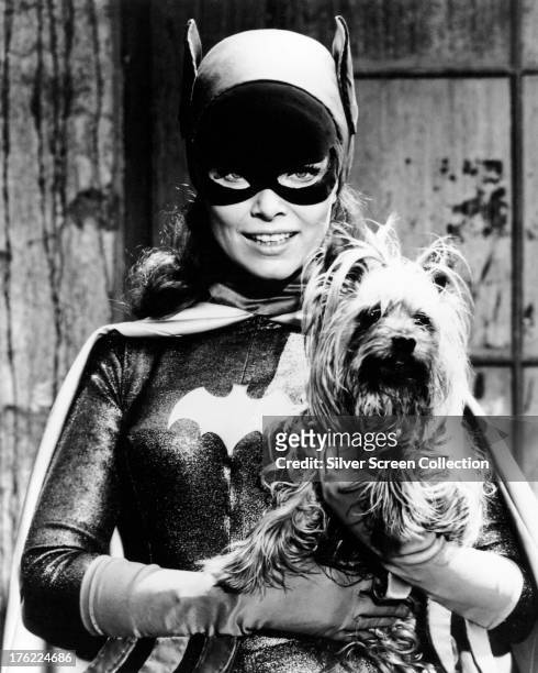 American actress Yvonne Craig as Batgirl/Barbara Gordon in the TV series 'Batman', circa 1967. Craig is holding her pet Yorkshire Terrier, Sebastian.