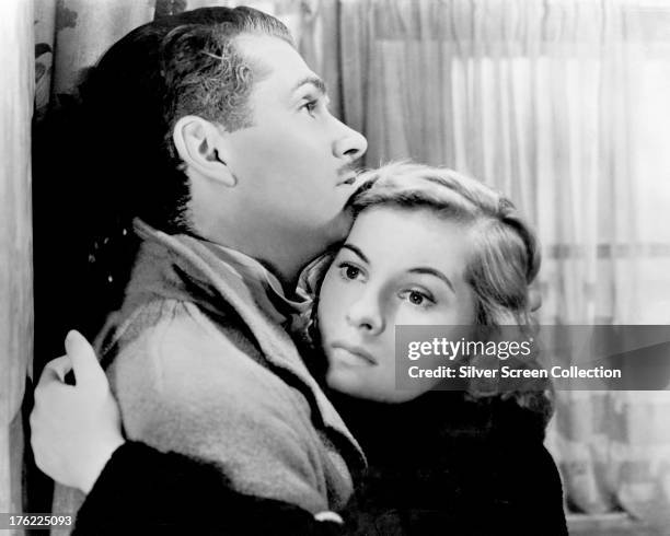 British actors Laurence Olivier , as Maxim de Winter, and Joan Fontaine as The Second Mrs. De Winter in 'Rebecca', directed by Alfred Hitchcock, 1940.