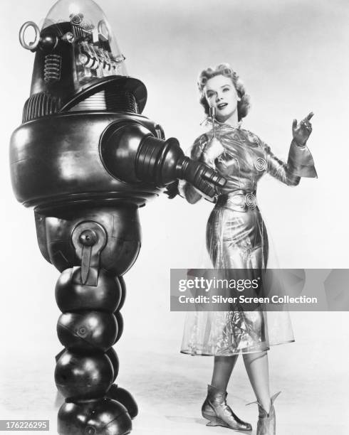 American actress Anne Francis as Altaira 'Alta' Morbius with Robby the Robot in a promotional portrait for 'Forbidden Planet', directed by Fred M....