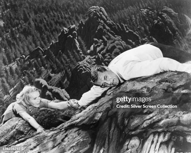 Roger O Thornhill, played by Cary Grant , and Eve Kendall, played by Eva Marie Saint, hanging from a cliff at Mount Rushmore in 'North By Northwest',...