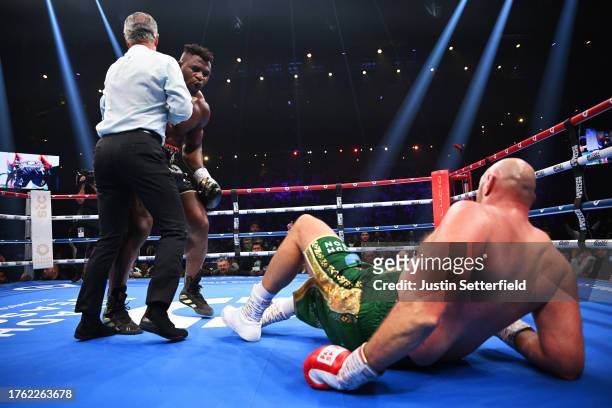 Francis Ngannou knocks down Tyson Fury during the Heavyweight fight between Tyson Fury and Francis Ngannou at Boulevard Hall on October 28, 2023 in...