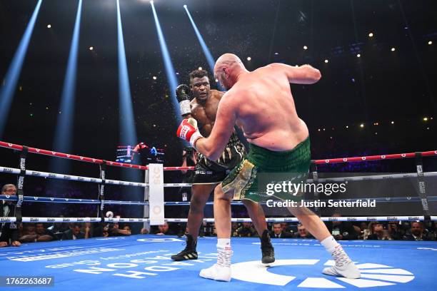 Francis Ngannou knocks down Tyson Fury during the Heavyweight fight between Tyson Fury and Francis Ngannou at Boulevard Hall on October 28, 2023 in...