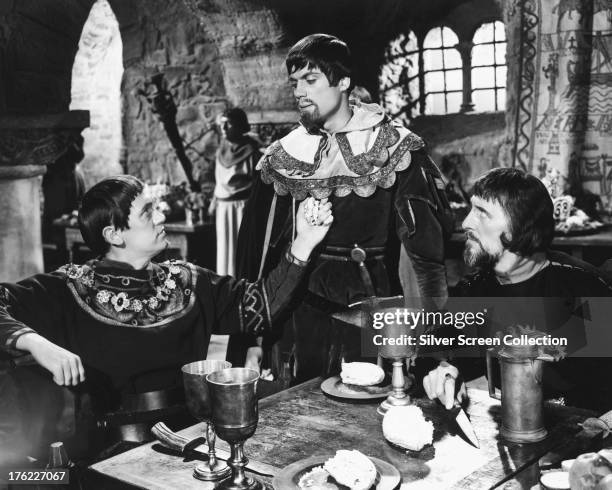 English actors Richard Pasco, as Edward, Earl of Newark, Oliver Reed as Lord Melton and Peter Cushing as the Sheriff of Nottingham, in 'Sword Of...