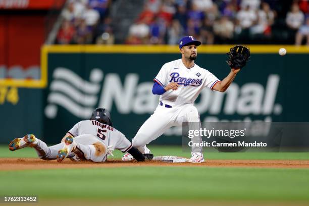 Marcus Semien of the Texas Rangers attempts to pick off Alek Thomas of the Arizona Diamondbacks at second base in the third inning during Game Two of...