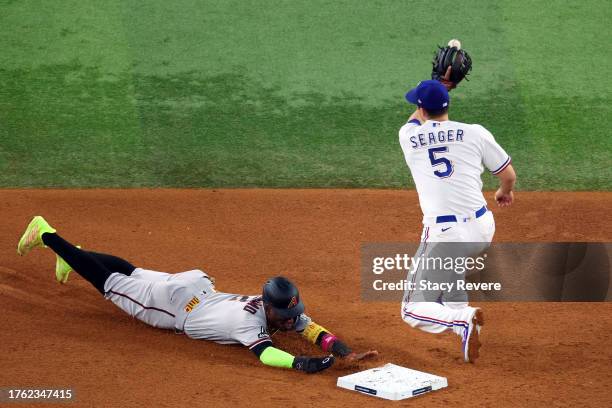 Geraldo Perdomo of the Arizona Diamondbacks steals second base past Corey Seager of the Texas Rangers in the fifth inning during Game Two of the...