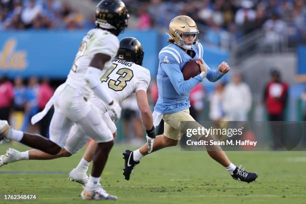 Ethan Garbers of the UCLA Bruins eludes Trevor Woods of the Colorado Buffaloes during the first half of a game at Rose Bowl Stadium on October 28,...