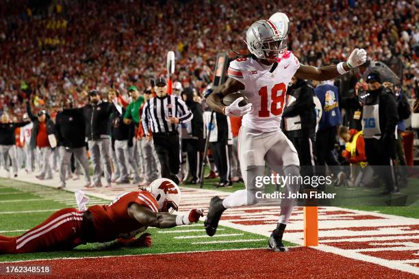 Marvin Harrison Jr. #18 of the Ohio State Buckeyes scores on a 16 yard touchdown pass during the second quarter against the Wisconsin Badgers at Camp...