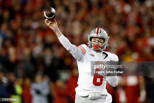 Kyle McCord of the Ohio State Buckeyes throws a pass during the first quarter against the Wisconsin Badgers at Camp Randall Stadium on October 28,...