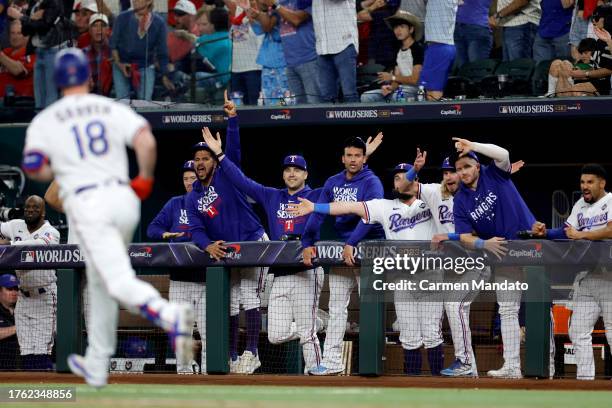 The Texas Rangers dugout celebrates after Mitch Garver of the Texas Rangers hit a home run in the fifth inning against the Arizona Diamondbacks...