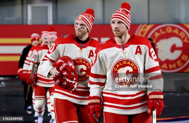 Elias Lindholm and Jonathan Huberdeau of the Calgary Flames and their teammates make their way to the ice surface before practice at Commonwealth...