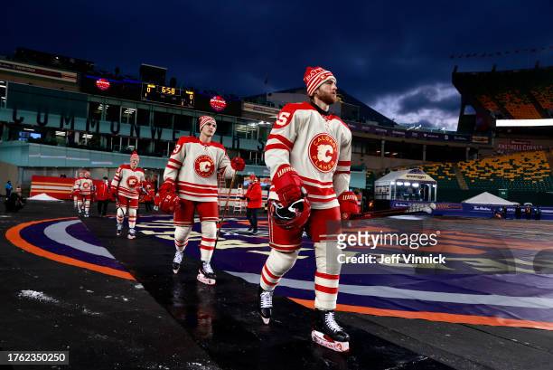 Adam Ruzicka and Noah Hanifin of the Calgary Flames and their teammates make their way to the ice surface before practice at Commonwealth Stadium on...