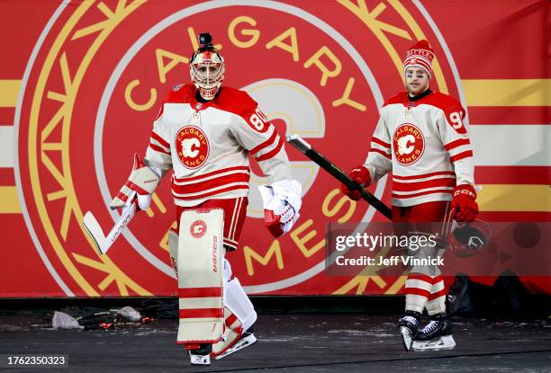 Goaltender Dan Vladar of the Calgary Flames and a teammate make their way to the ice surface before practice at Commonwealth Stadium on October 28,...