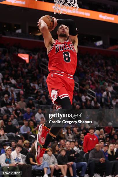 Zach LaVine of the Chicago Bulls dunks in the second half while playing the Detroit Pistons at Little Caesars Arena on October 28, 2023 in Detroit,...