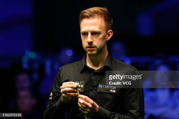 Judd Trump of England chalks the cue in the Semi-final match against Barry Hawkins of England on day seven of 2023 Northern Ireland Open at...
