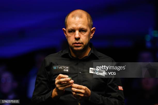Barry Hawkins of England chalks the cue in the Semi-final match against Judd Trump of England on day seven of 2023 Northern Ireland Open at...
