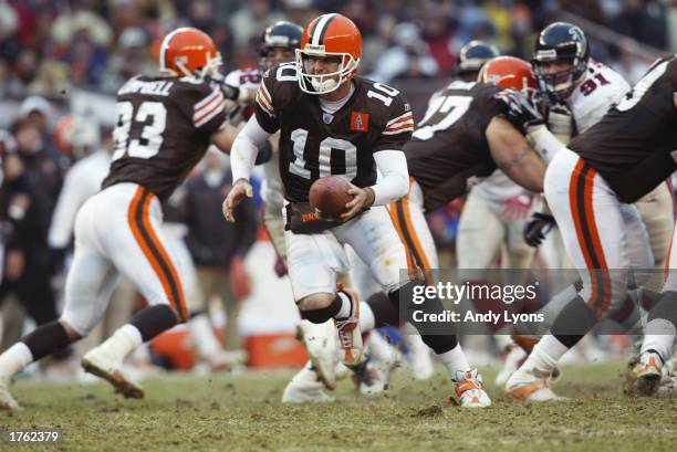 Quarterback Kelly Holcomb of the Cleveland Browns attempts to hand off the ball against the Atlanta Falcons during the NFL game at Cleveland Browns...