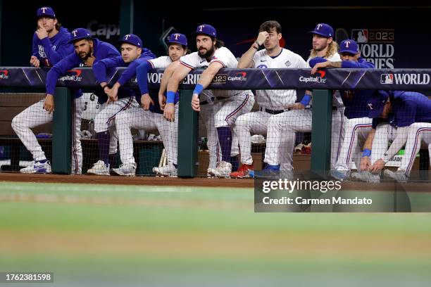 Members of the Texas Rangers look on from the dugout in the seventh inning against the Arizona Diamondbacks during Game Two of the World Series at...