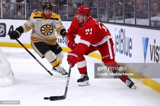 Dylan Larkin of the Detroit Red Wings skates against Matt Grzelcyk of the Boston Bruins during the second period at TD Garden on October 28, 2023 in...