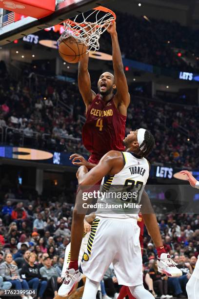 Evan Mobley of the Cleveland Cavaliers dunks over Myles Turner of the Indiana Pacers during the first half at Rocket Mortgage Fieldhouse on October...