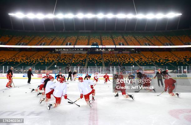 The Calgary Flames stretch at center ice during practice at Commonwealth Stadium on October 28, 2023 in Edmonton, Alberta.