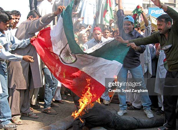 Pakistani Kashmiri protestors burn an Indian flag during an anti-Indian protest on the eve of Kashmir day February 5, 2003 in Karachi, Pakistan. They...