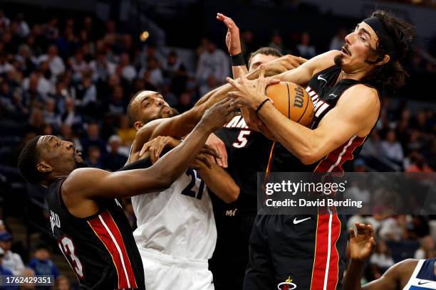 Jaime Jaquez Jr. #11 of the Miami Heat rebounds the ball against Rudy Gobert of the Minnesota Timberwolves in the third quarter at Target Center on...