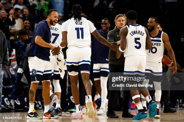 Naz Reid of the Minnesota Timberwolves celebrates with teammates during a timeout against the Miami Heat in the fourth quarter at Target Center on...