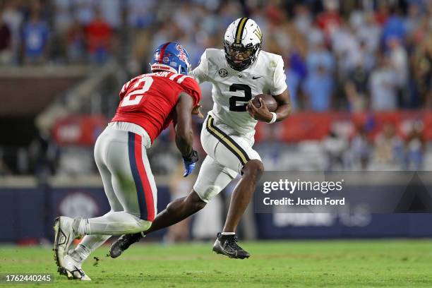 Walter Taylor of the Vanderbilt Commodores carries the ball against Cedric Johnson of the Mississippi Rebels during the second half at...