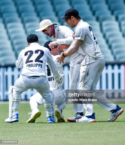 Cameron Bancroft of Western Australia celebrates after catching the wicket of Jake Lehmann captain of the Redbacks with his team mates during the...