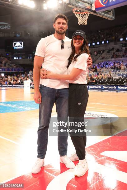 Megan Gale and Shaun Hampson pose for a photo pre-game during the round five NBL match between Melbourne United and Illawarra Hawks at John Cain...