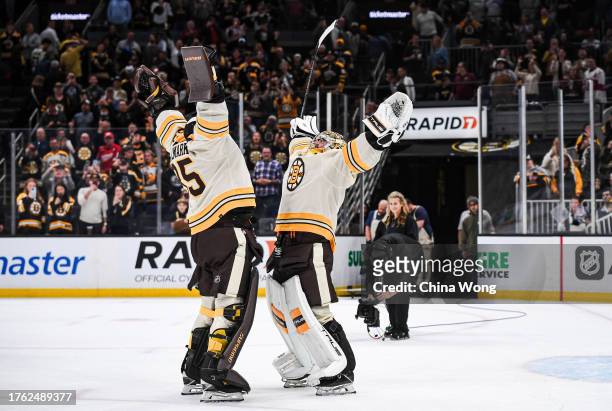 Jeremy Swayman of the Boston Bruins and Linus Ullmark celebrate a win against the Detroit Red Wings at TD Garden on October 28, 2023 in Boston,...