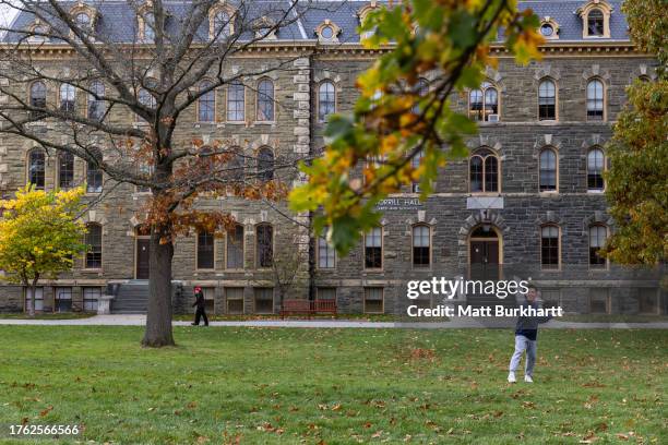 Cornell University student plays frisbee in a quad on campus on November 3, 2023 in Ithaca, New York. The university canceled classes after one of...