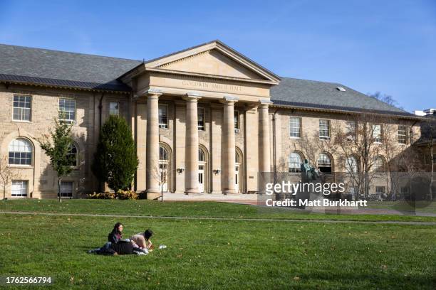 Cornell University students sit outside on November 3, 2023 in Ithaca, New York. The university canceled classes after one of its students is accused...