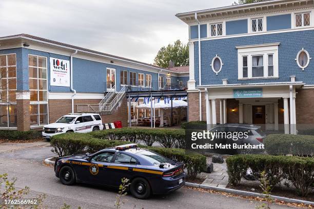 Cornell University campus police officer and a state trooper sit parked outside the Center for Jewish Living on November 3, 2023 in Ithaca, New York,...