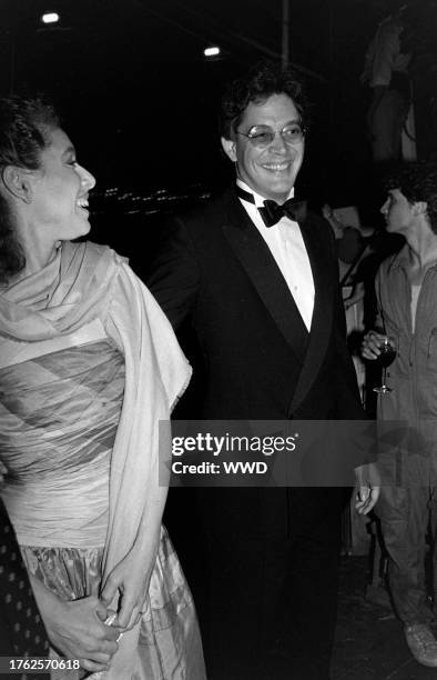Merel Poloway and Raul Julia attend a party aboard the "Peking," docked at New York City's South Street Seaport, on August 9, 1982.