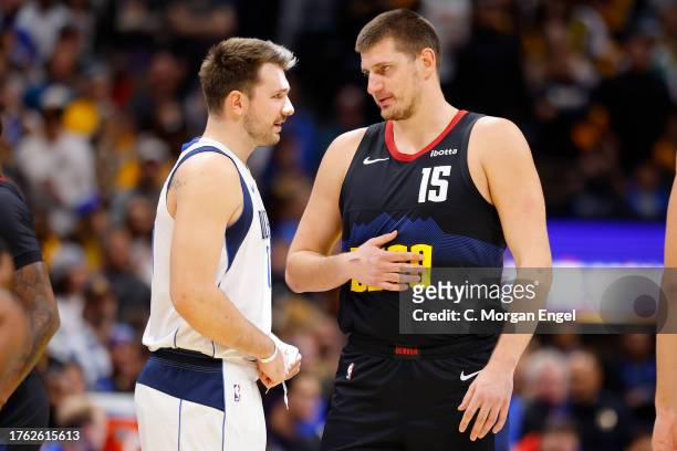 Luka Doncic of the Dallas Mavericks and Nikola Jokic of the Denver Nuggets talk before tip-off during the NBA In-Season Tournament game at Ball Arena...