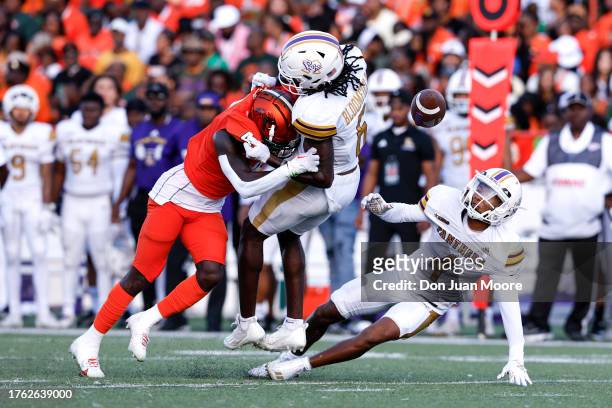 Defensive Back Kym'Mani King of the Florida A&M Rattlers makes a hard tackle and fumble on Wide Receiver Jahquan Bloomfield of the Prairie View A&M...