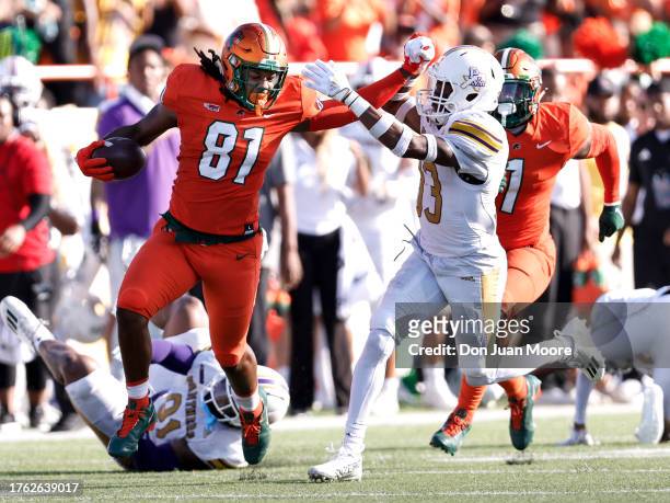 Tight End Kamari Young of the Florida A&M Rattlers makes a catch and run while trying to stiff arm Safety Tariq Mulmore of the Prairie View A&M...