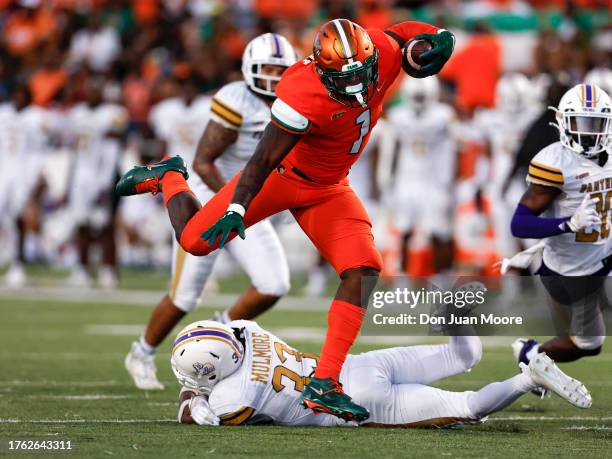 Runningback Jaquez Yant of the Florida A&M Rattlers leapas over Safety Tariq Mulmore of the Prairie View A&M Panthers during the game at Bragg...