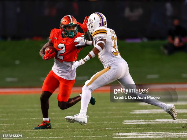 Wide Receiver Jamari Gassett of the Florida A&M Rattlers gives a stiff arm after a catch and run against Safety Tariq Mulmore of the Prairie View A&M...