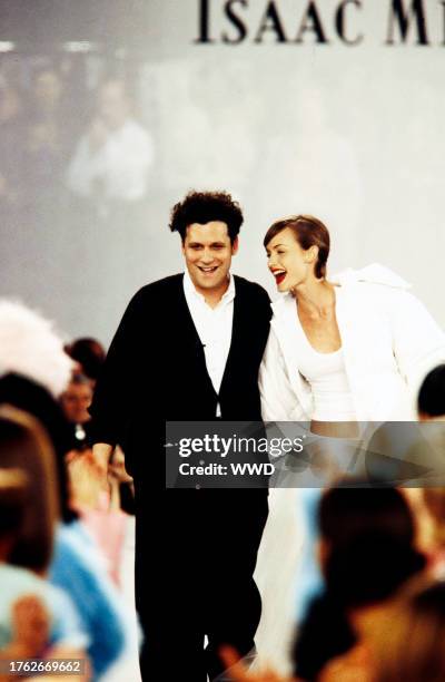 Designer Isaac Mizrahi and model Amber Valletta walk down the runway during fashion show finale. ; The filming of this fashion show is part of the...