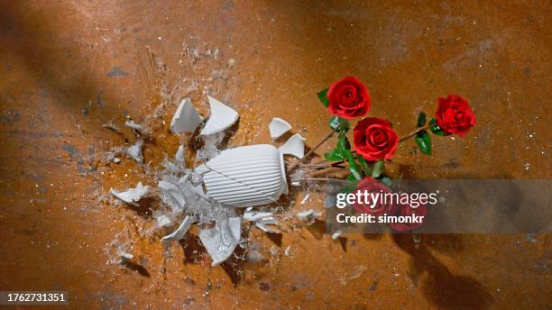 broken vase with red roses - broken vase stock pictures, royalty-free photos & images